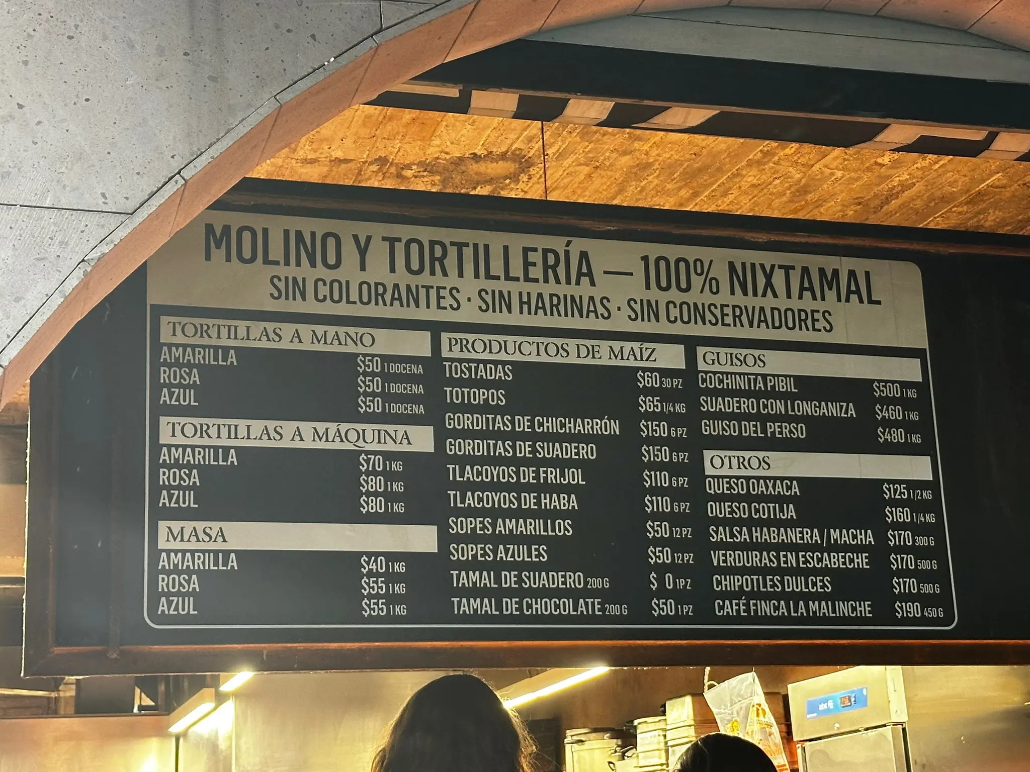 A sign above Maizajo’s to-go window showing all of their options and their prices.